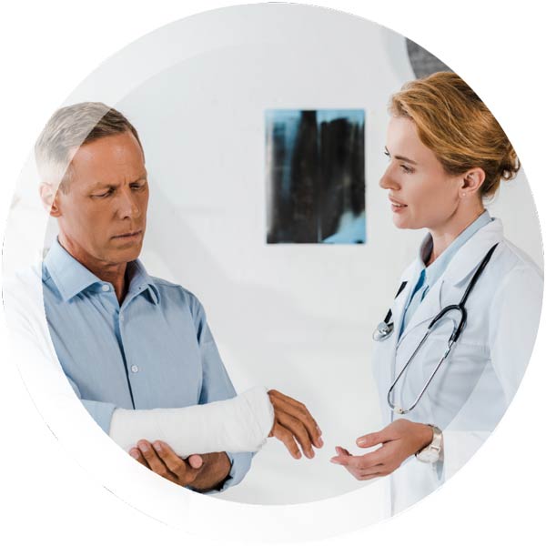 Man with cast on his arm, talking to a doctor