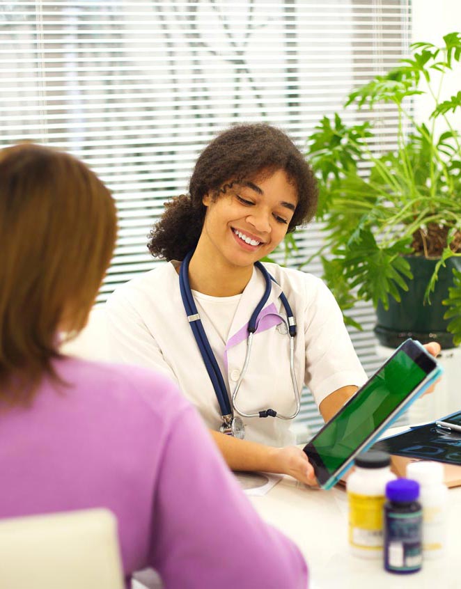 Happy doctor and patient looking at screen of tablet