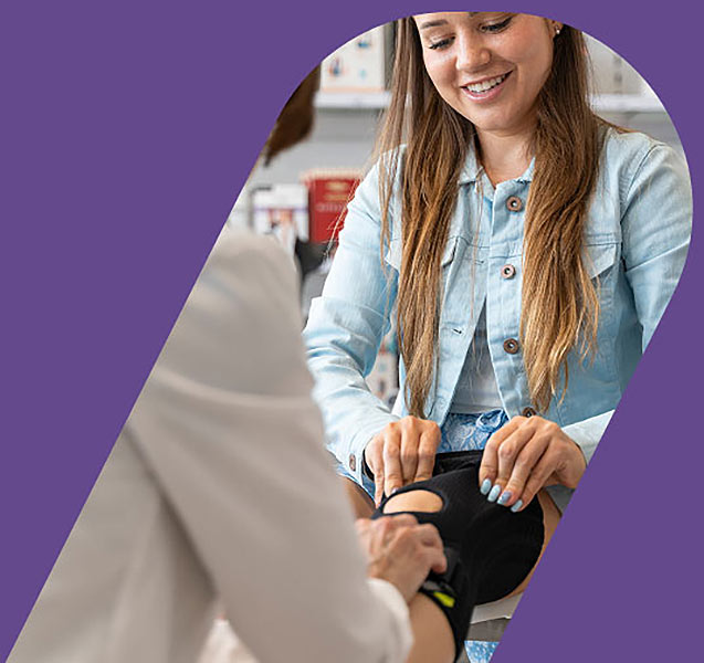Young woman being fitted for a knee brace