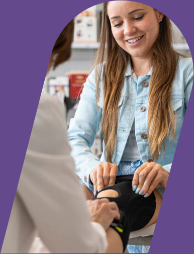 Young woman being fitted for a knee brace