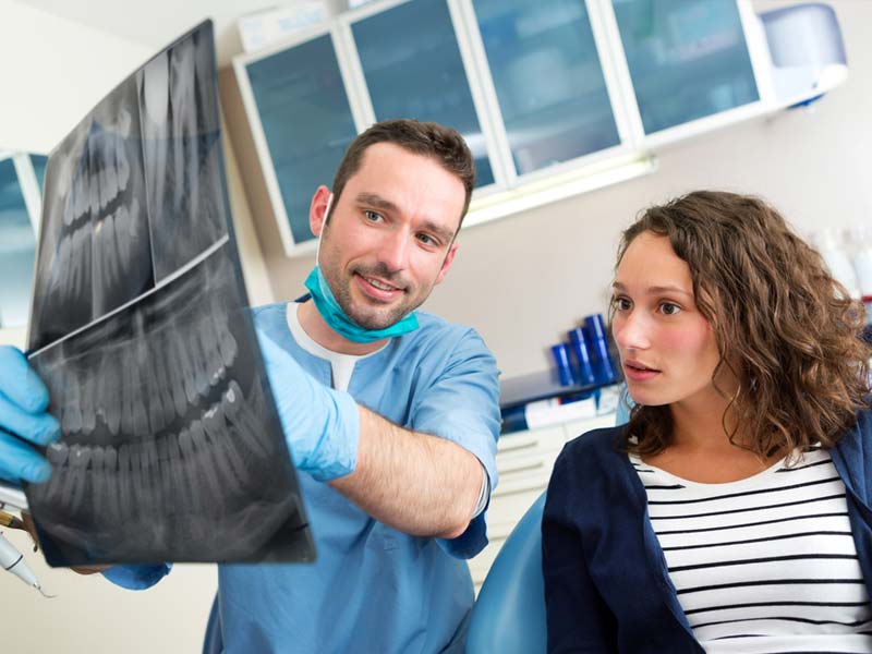 Dentist reviewing xray with patient